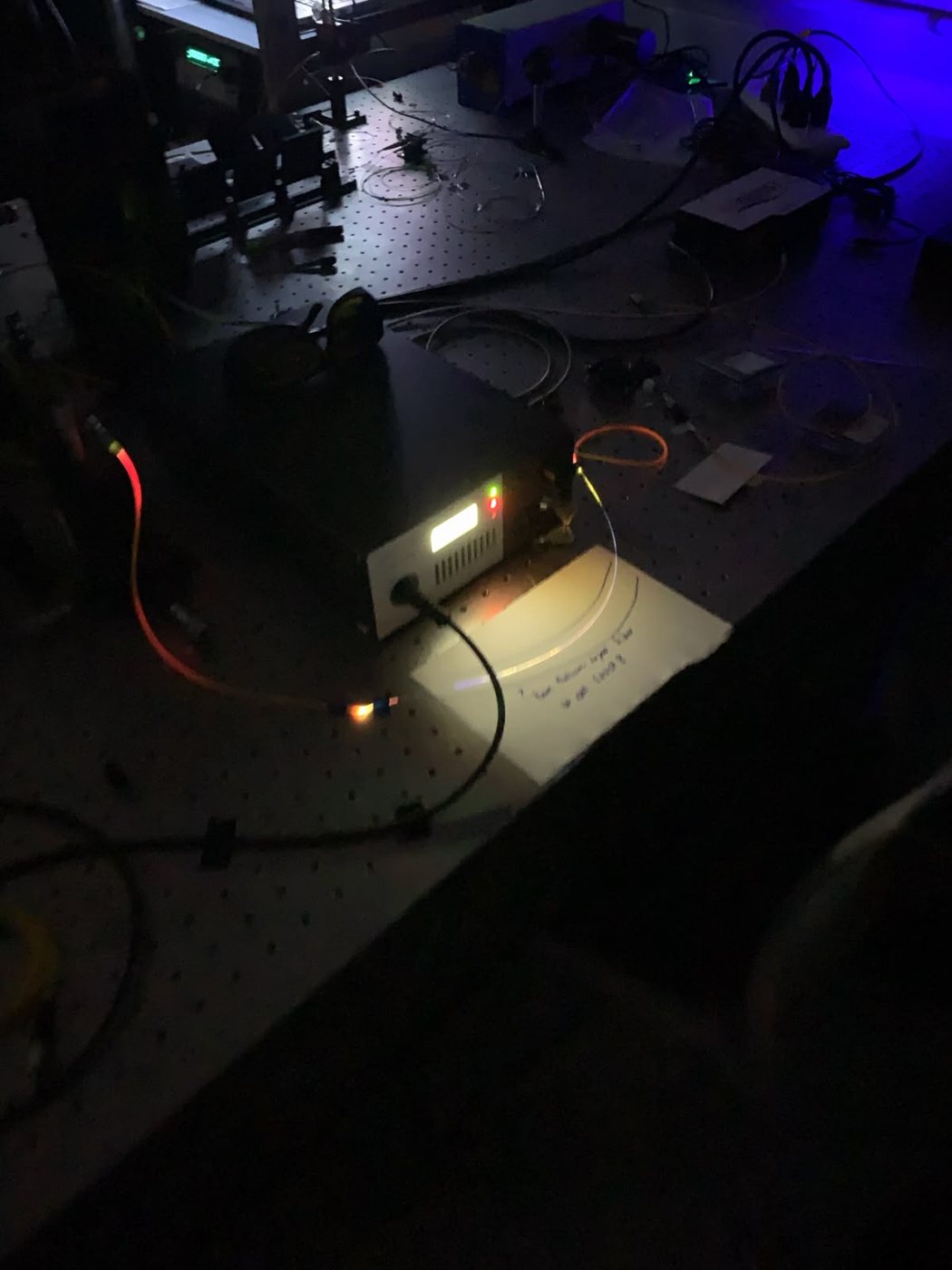 Dimly lit optical lab with spectroscopy equipment