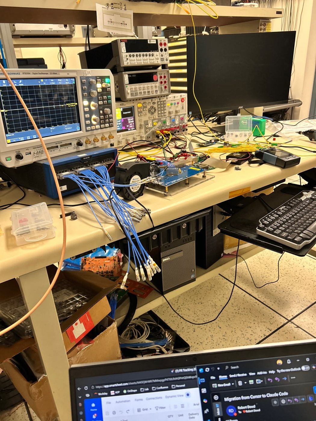 Lab bench with oscilloscopes, instruments and cabling